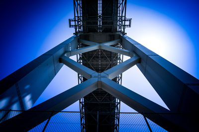 Low angle view of metallic structure against blue sky
