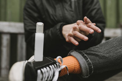 Cleaning hands with hand sanitizer