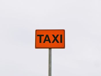 Low angle view of road sign against clear sky