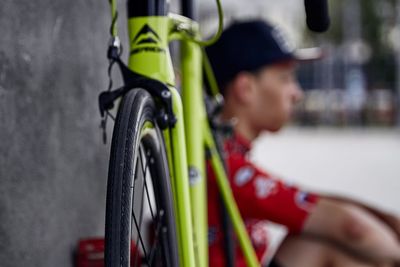 Close-up of bicycle with man in background