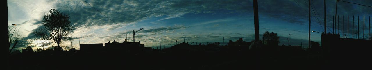 architecture, building exterior, built structure, silhouette, sky, city, building, low angle view, residential structure, residential building, house, cloud - sky, dusk, cloud, no people, dark, development, outdoors, window, electricity pylon