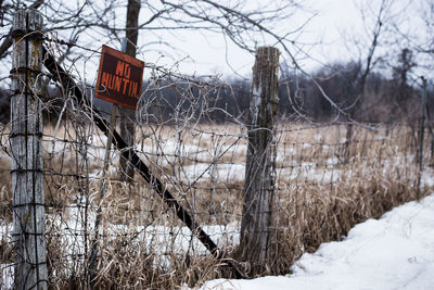 No hunting sign on fence during winter