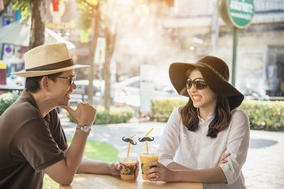 Couple drinking on table outdoors