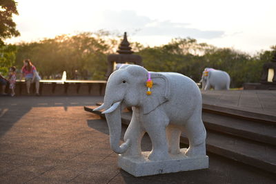 Elephant statue on field at temple