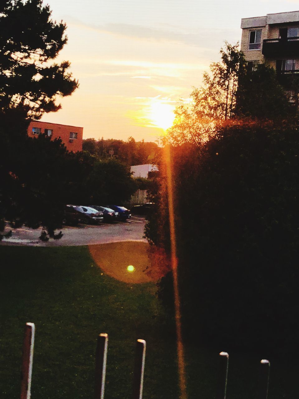 VIEW OF CITY STREET AGAINST SKY AT SUNSET