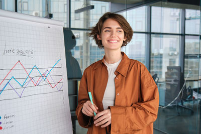Portrait of young businesswoman standing in office