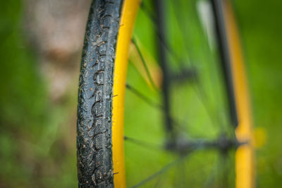 Photo of a bicycle part, close up. in the open air, the wheel and tread are clearly visible.