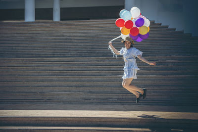 Full length of a woman holding balloons