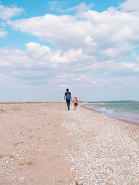 People on beach against sky