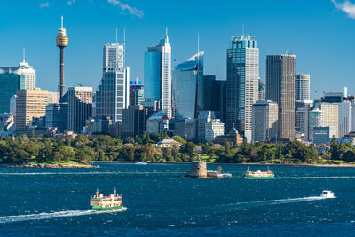 Sydney cityscape view with yachts and ferries over sydney harbour on sunny day