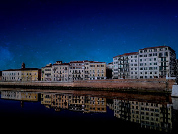 Buildings against blue sky at night