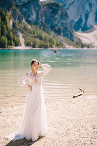 Woman with umbrella on shore