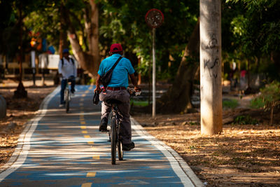 Cyclist at the ronda del sinu path along the river bank in the city of montería, colombia.