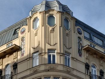 Low angle view of building against blue sky