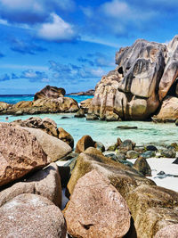 Rocks on beach against sky