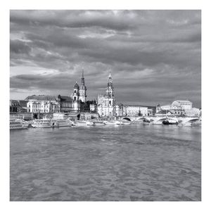 View of boats in sea against cloudy sky