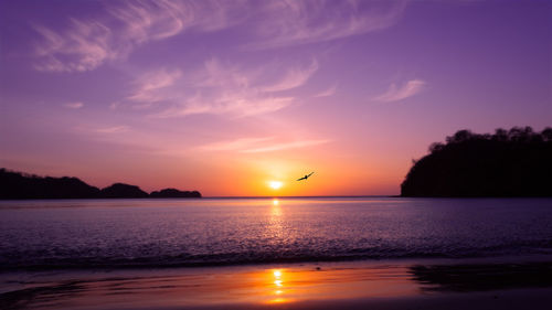 Scenic view of sea against clear sky during sunset