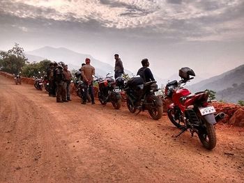 People riding motorcycle on road