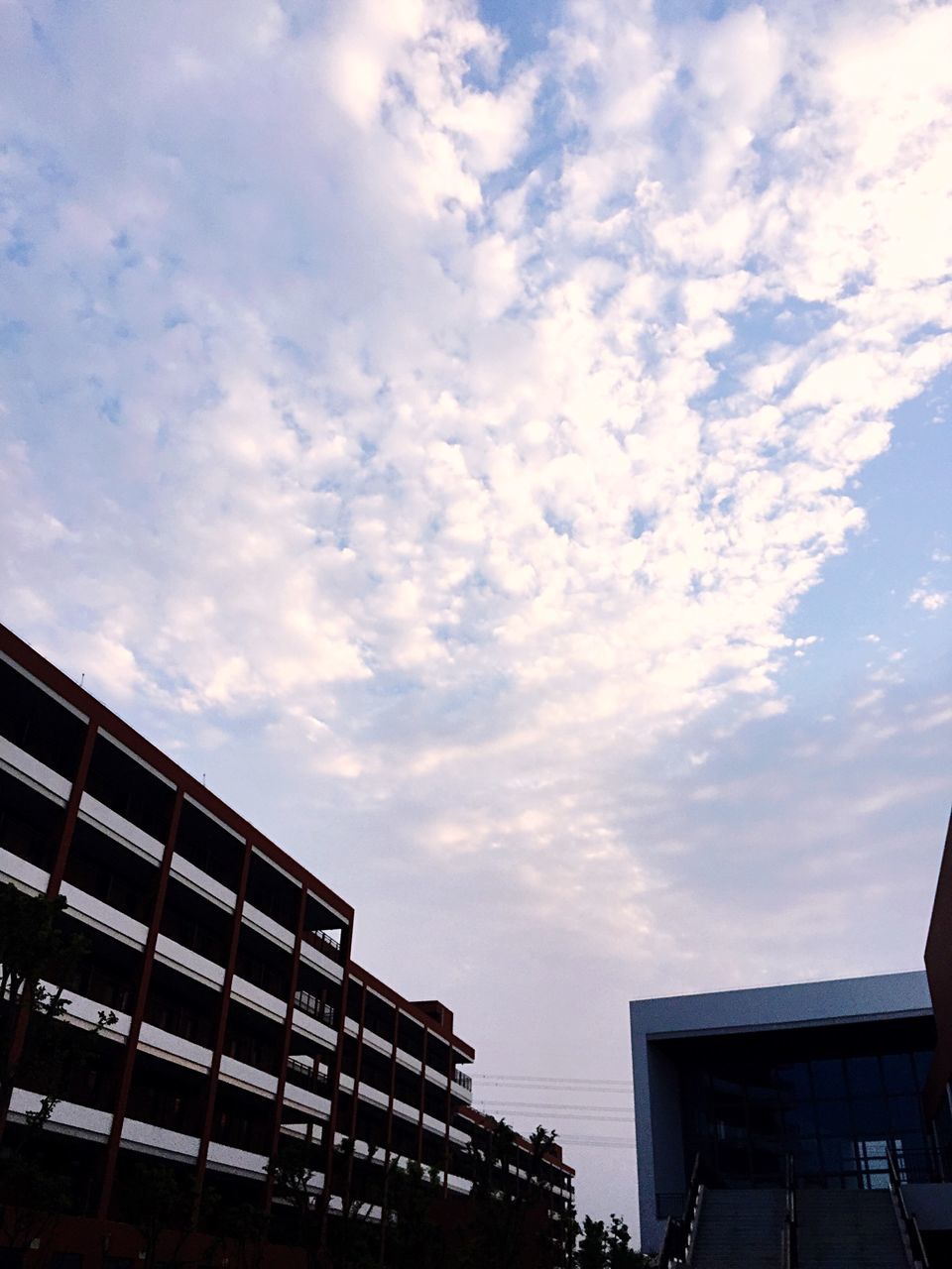 building exterior, architecture, built structure, low angle view, sky, city, building, cloud - sky, residential building, residential structure, cloud, cloudy, window, office building, modern, outdoors, high section, no people, day, apartment