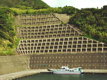 View of boats in river against building