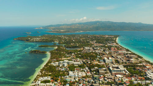 Costline of the tropical island of boracay with sandy beaches and hotels from above. 