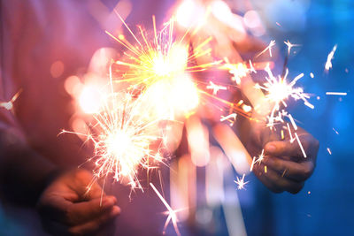 Low angle view of firework display at night