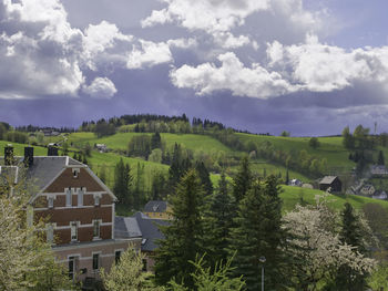 Scenic view of trees and buildings against sky