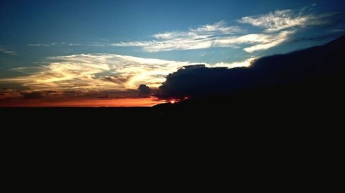 Silhouette of mountain against sky at sunset