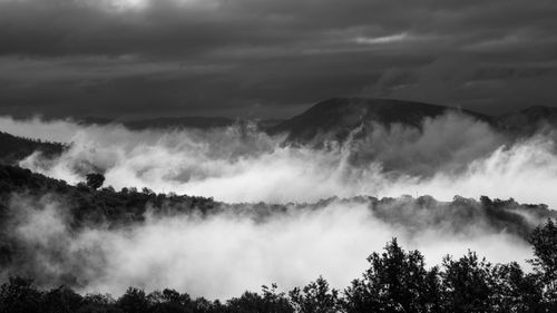 Scenic view of clouds covering mountains