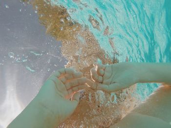 Cropped image of boy swimming in pool