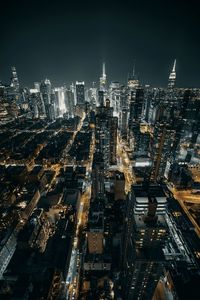 High angle view of city lit up at night