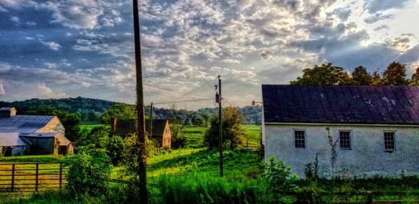 Panoramic view of trees and houses against sky