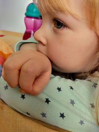 Close-up of cute boy drinking glass at home