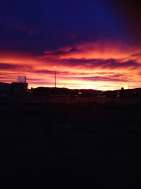 Silhouette buildings against sky during sunset