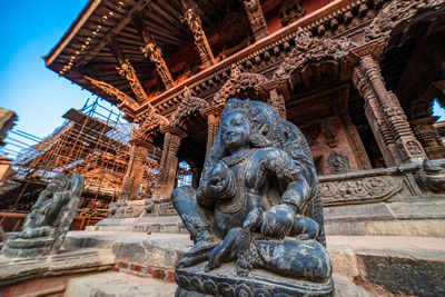 Low angle view of statue against historic building