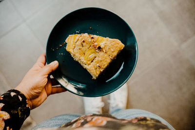 Cropped hand of person holding food