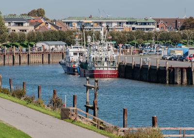 Fishing boats moored on sea at harbor