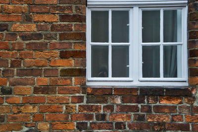 Full frame shot of window on brick wall of building