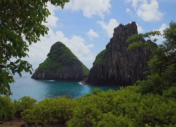 Scenic view of sea and mountains against sky