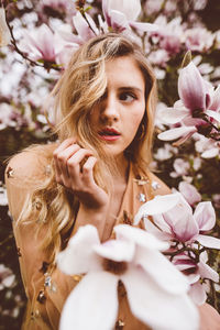 Portrait of beautiful woman with pink flowers