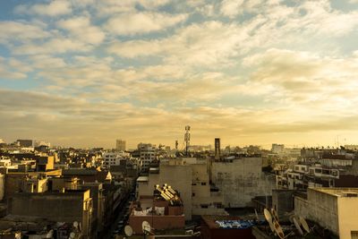 High angle view of city against cloudy sky