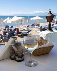 Close-up of wine on table at beach