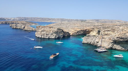 High angle view of sailboats in sea against clear sky