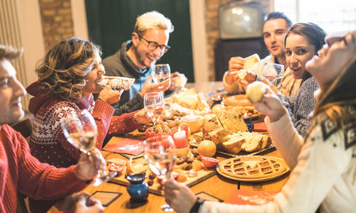 People enjoying food and drink on table