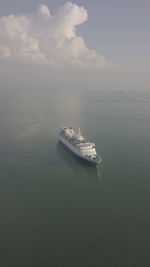 Boat sailing in sea against sky