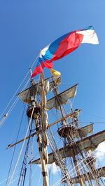 Low angle view of russian flag on mast against sky