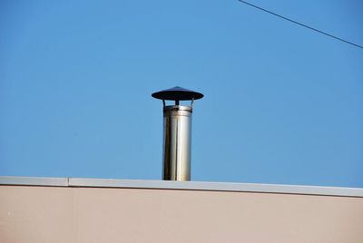 Low angle view of bell tower against clear blue sky