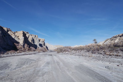 Road in desert against blue sky