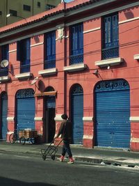 Full length of man walking on road in city