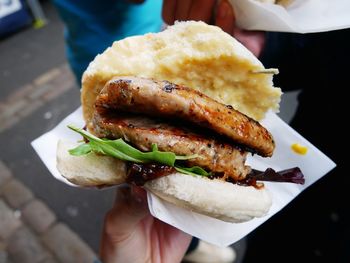 Close-up of hand holding burger